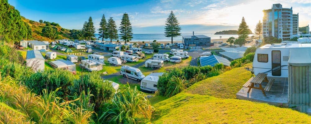 An aerial view of caravan parks on the Australian beach, showcasing the funding commitment by the Caravan Industry Association.