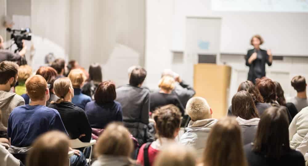 A woman giving a media training session presentation to an audience during Move America Week.