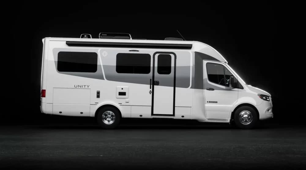 A white Triple E RV with a black background.