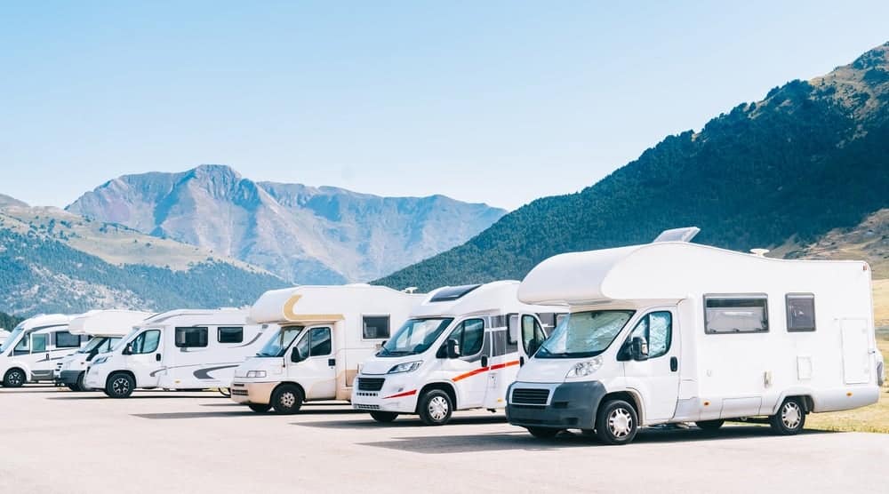 The Canadian Gov't proposes limiting formaldehyde emissions in a row of RVs parked in front of mountains.