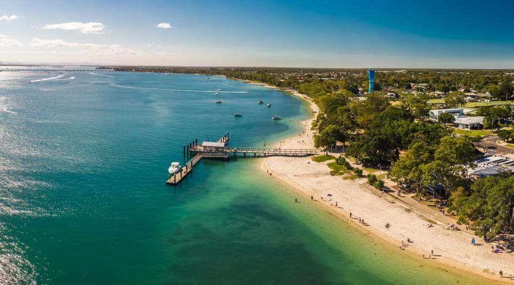 An aerial view of a beach and water on Bribie Island, offering outdoor recreation opportunities along the Northern Access Track.