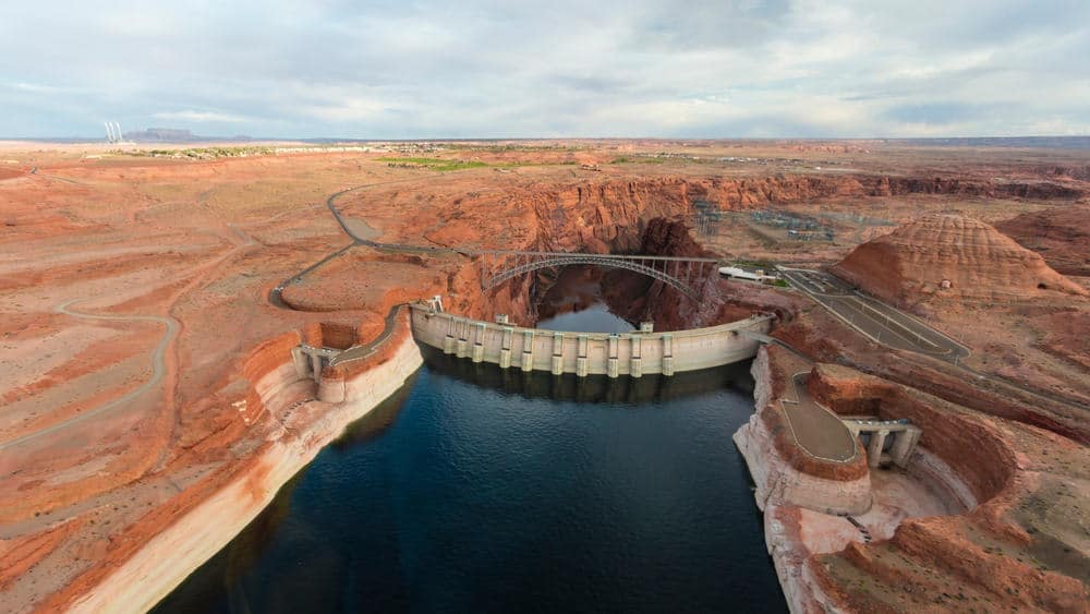 An aerial view of the Powell Dam located in Arizona's Glen Canyon National Recreation Area, showcasing its remarkable beauty and potential for tourism. The site offers significant economic benefits to the surrounding region.