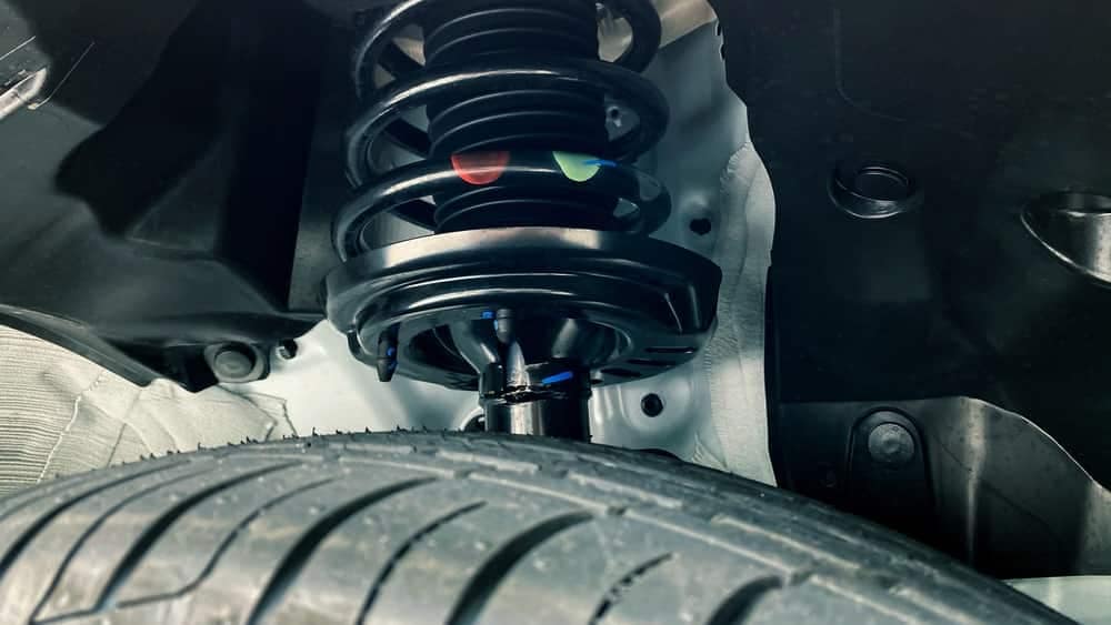 A black car with SumoSprings attached to its suspensions.