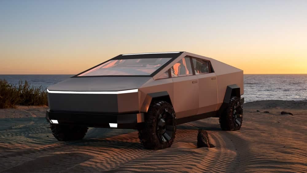 A Tesla Cybertruck, equipped with a cutting-edge 48V system, is parked on the beach.