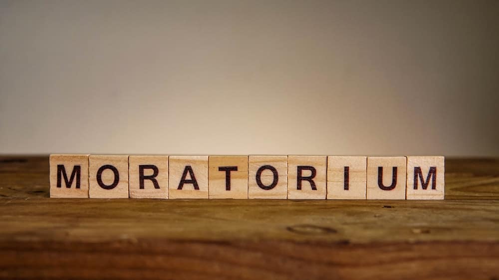 A wooden block with the word moratorium on it, symbolizing the proposed development freeze in Lamoine to protect against the establishment of a luxury glampground.