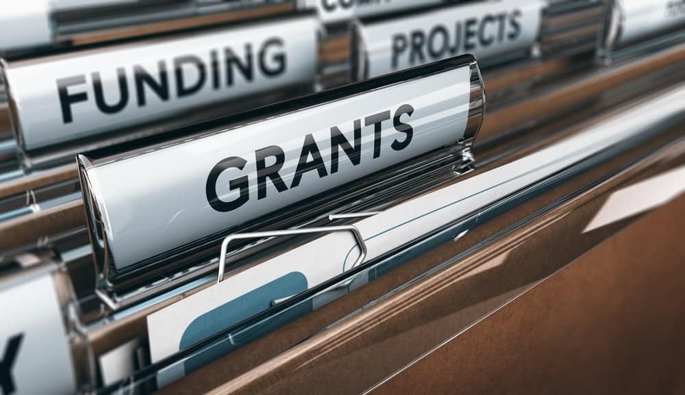 A file folder with the word funding on it.