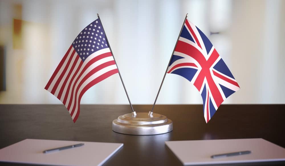Two U.K. and U.S. flags on a table.