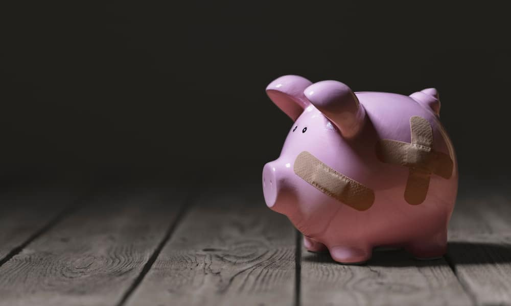 A pink piggy bank with a bandage on it, symbolizing economic aid during times of accelerating price increases.