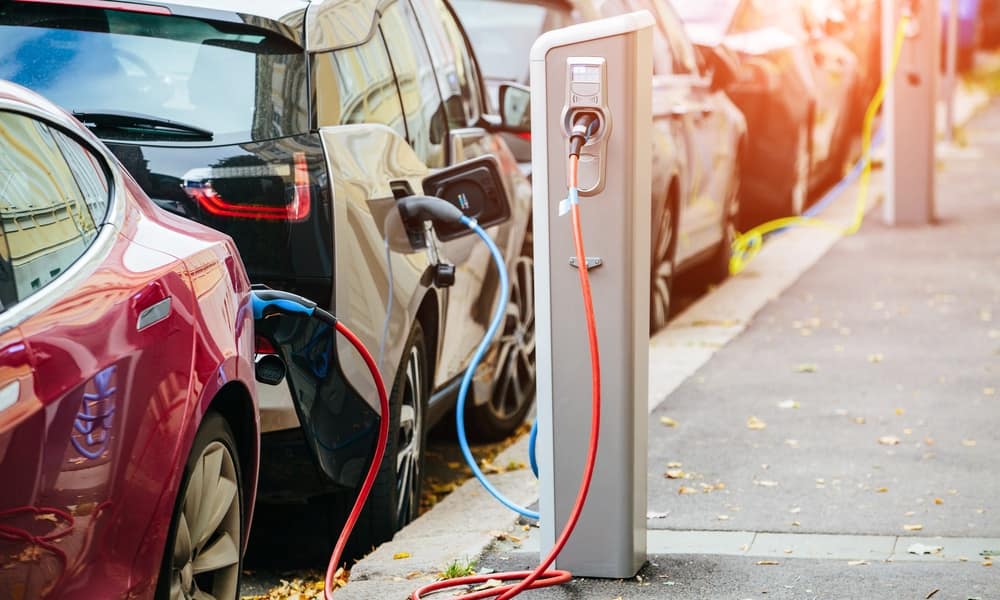 A car is plugged into an electric charging station.