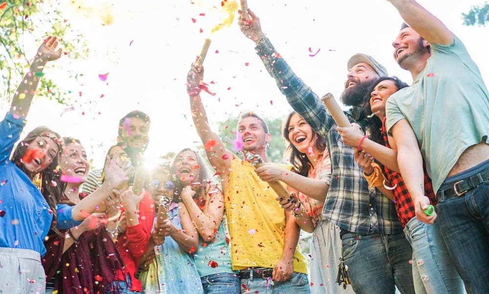 A group of people in Australia celebrates 70 years by throwing confetti in the air.
