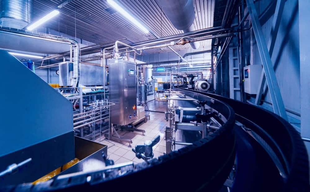 An image of a Crusader in a factory conducting operations on a conveyor belt.