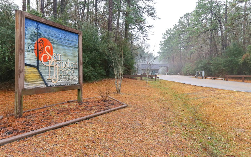 A sign in the middle of Sam Houston Jones State Park.