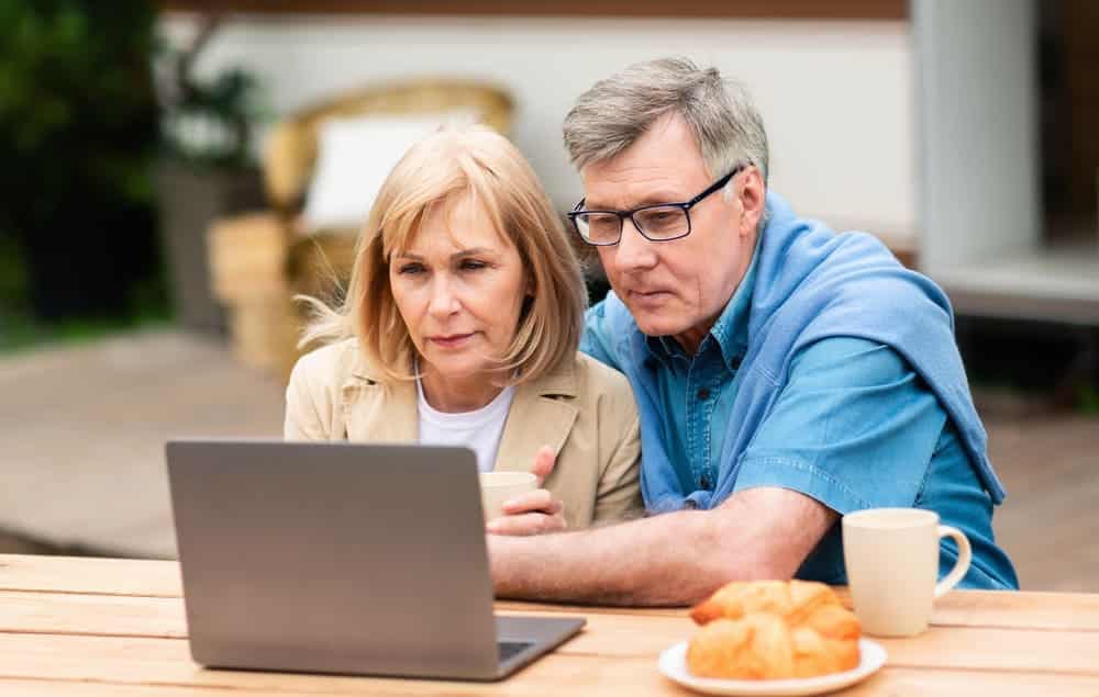 An older couple exploring the RV industry on their laptop.