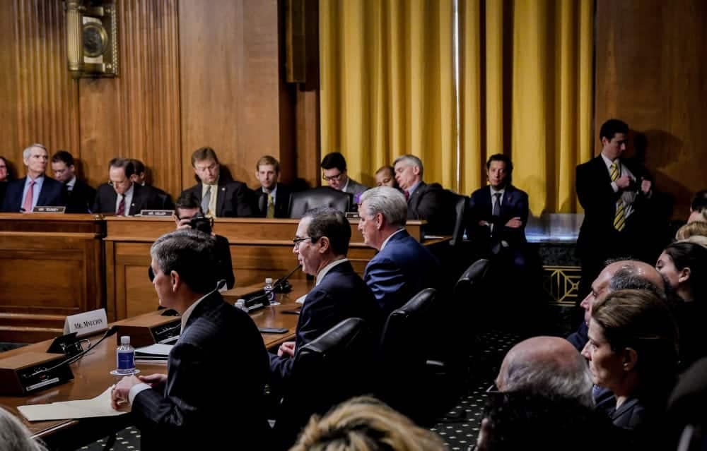 Members of the Senate Committee sitting at a table during a vote on the CORE Act.