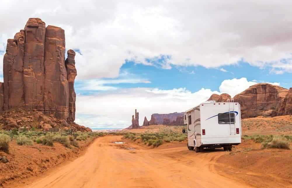 An RV parked on a dirt road in Monument Valley with good record.