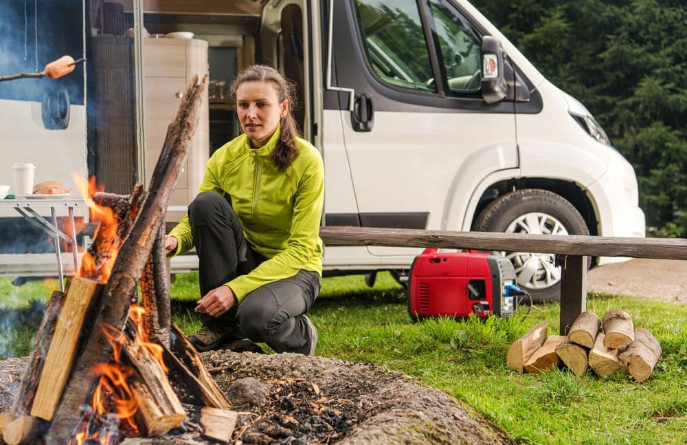 A Grass Valley resident is preparing a campfire in front of an RV.