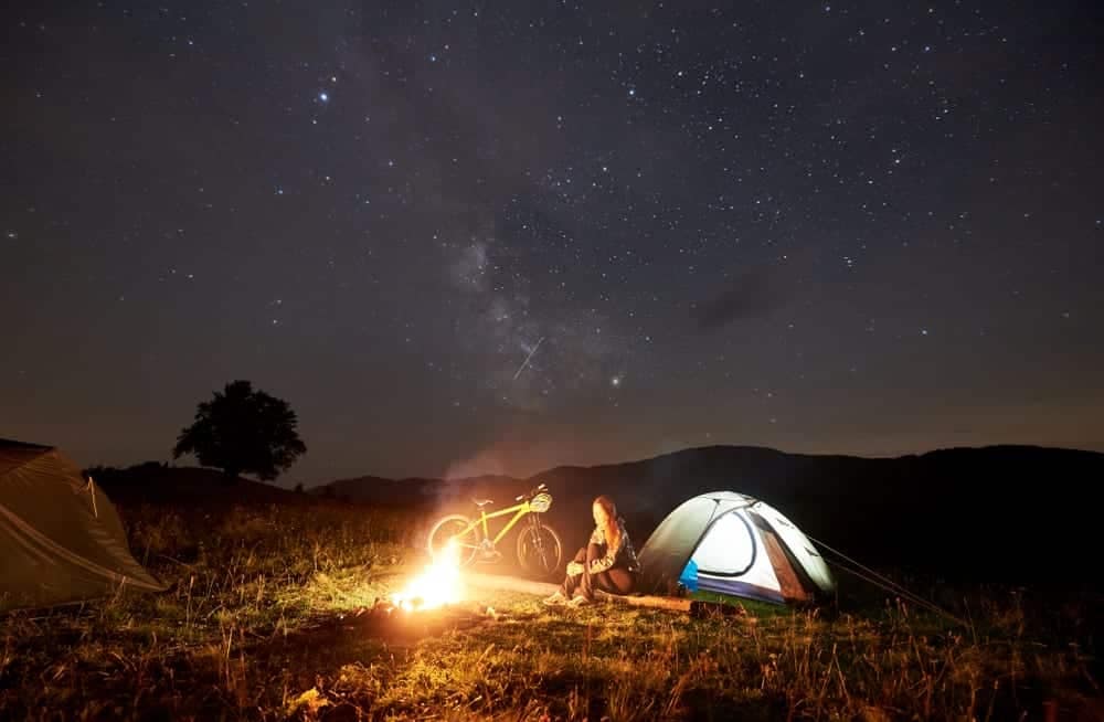 A camper enjoys a cozy evening under the stars at Chinook Park, where County officials have recently completed campground upgrading.