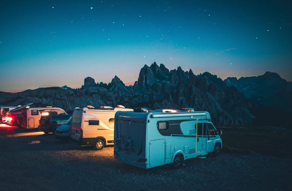 Three rvs parked in the mountains at night, showcasing the Ohio RV Supershow and 2022 models at Cleveland's I-X Center.