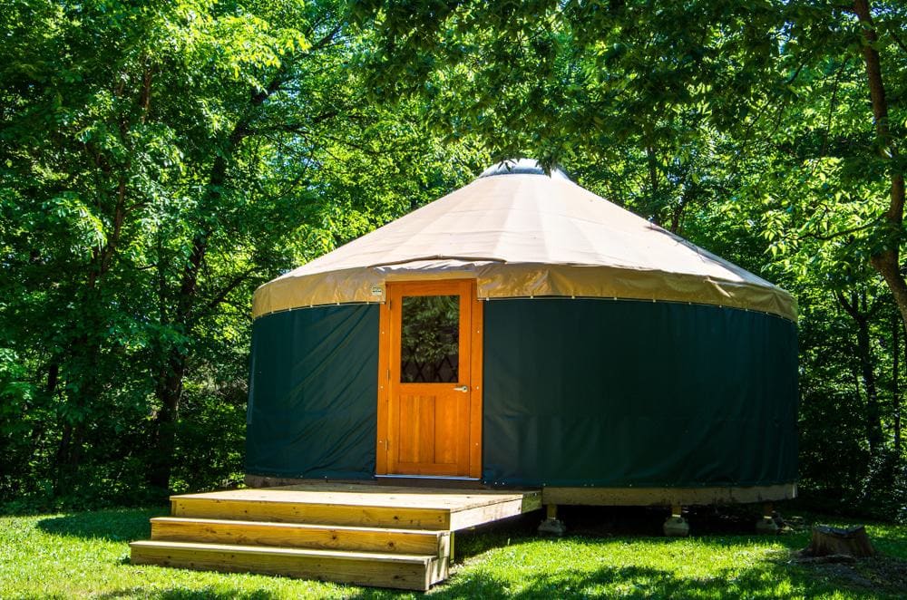 A yurt campground nestled in the middle of a beautiful wooded area in Maine, perfect for a romantic getaway for a couple.