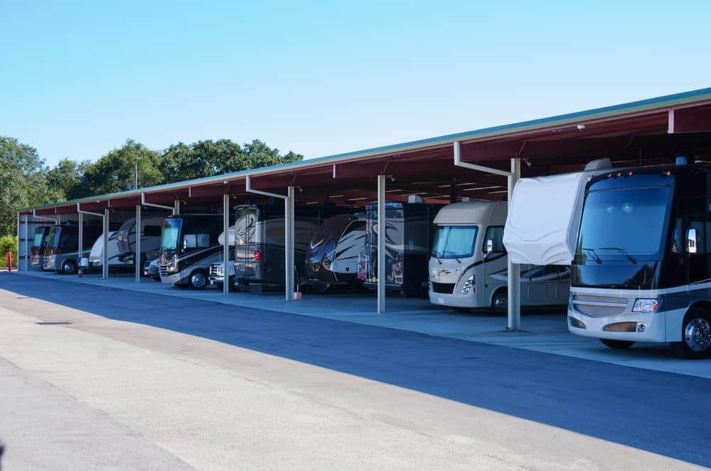 RecNation announces expansion with a group of RVs parked in a parking lot.