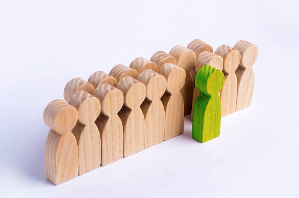 A group of wooden people standing next to each other at Camping World.