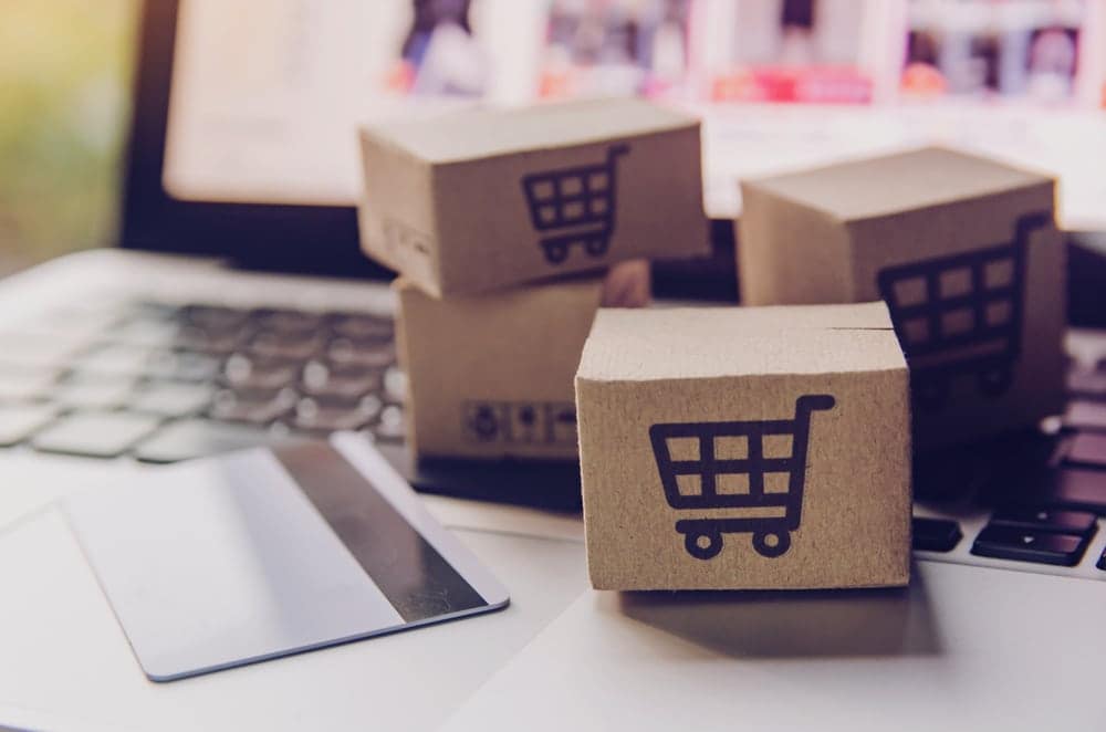 A user-friendly online store designed for Australian RVers, featuring an enticing laptop display with a shopping cart and credit card, offering a wide selection of caravan camping sales.