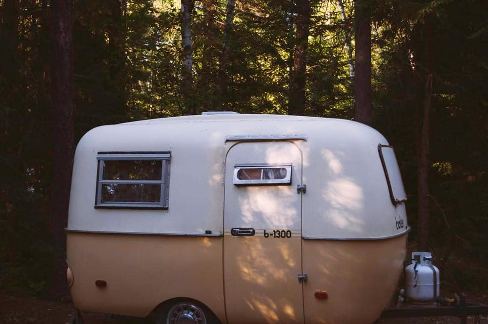 A Canada-designed camper trailer nestled in the woods.