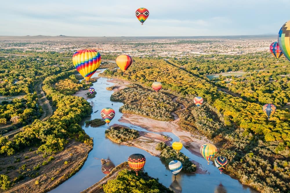 Hot air balloons floating over the beautiful New Mexico landscape, providing an exciting outdoor recreation experience.