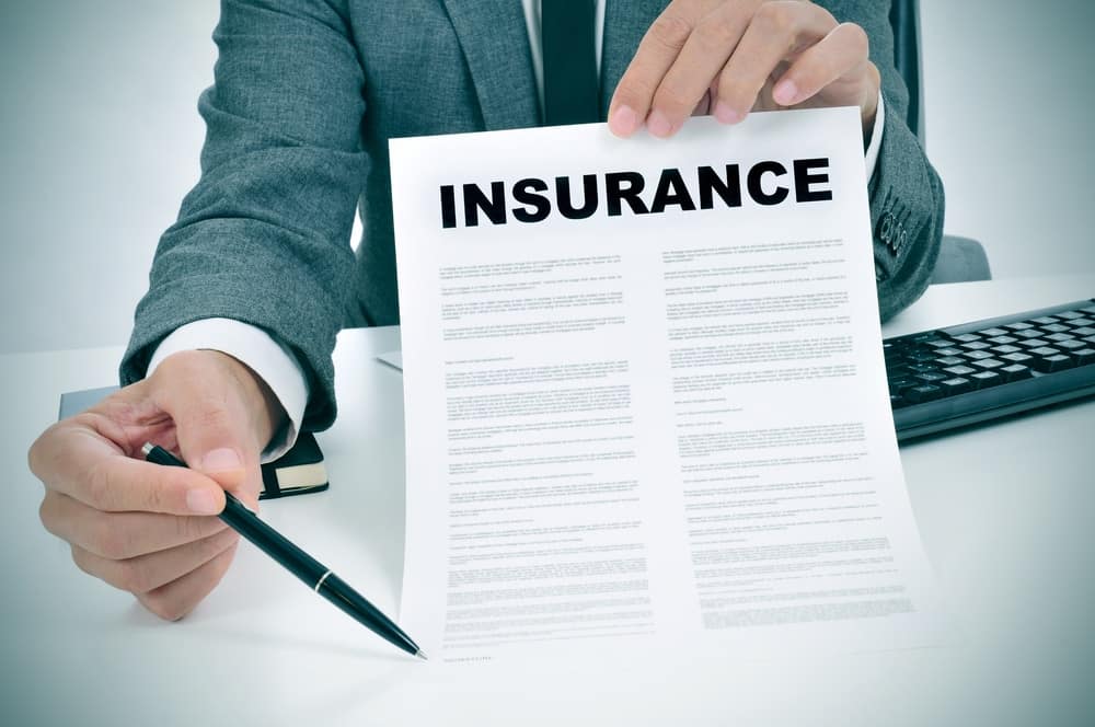 A man holding a paper with the word insurance on it, highlighting the recent changes in Florida RV Park Insurance.