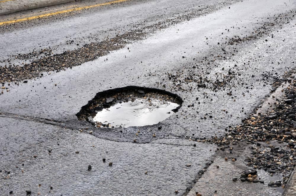 An unkept hole in the middle of the road causing frustration.