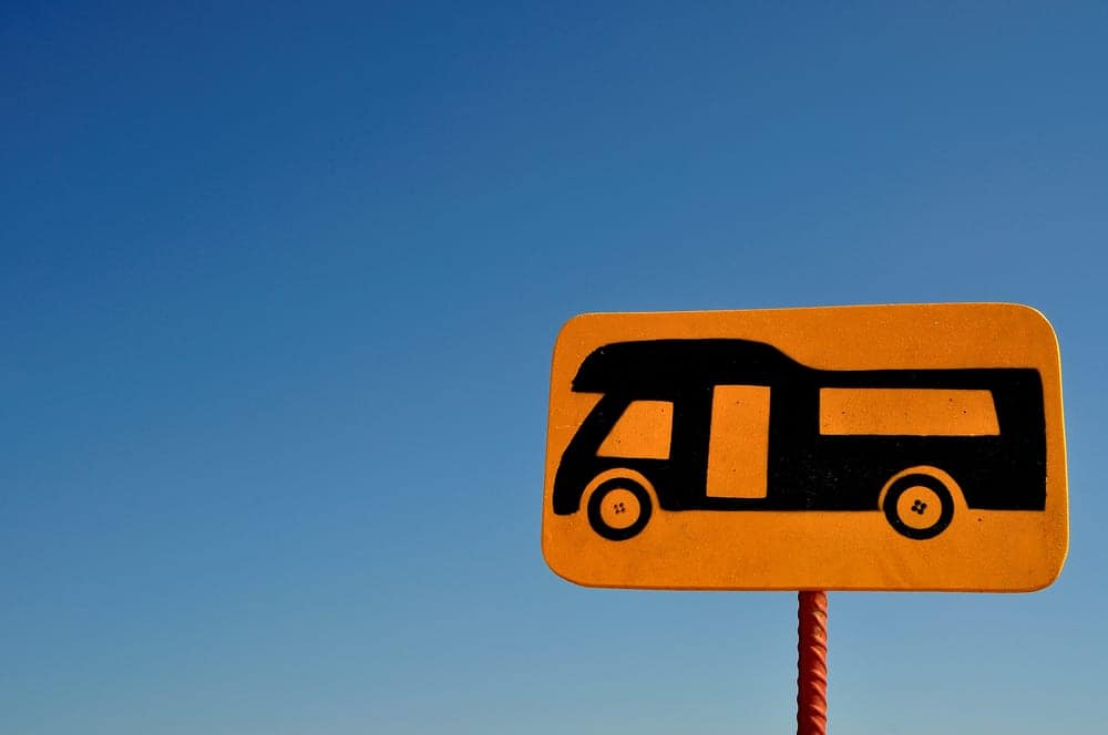 An outdoor enthusiasts sign with a rv on it, promoting the RV Parking Permit System in Sharjah.
