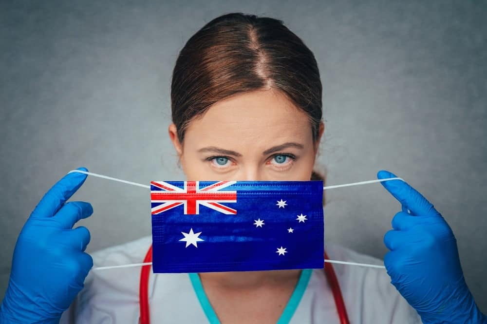 A female doctor donning an Australian flag face mask, diligently working amidst the NSW COVID outbreak.