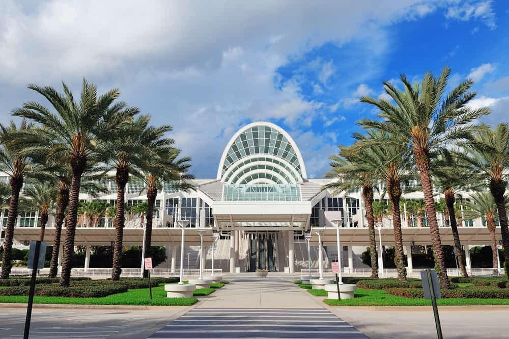 A Kampgrounds of America building with palm trees in front of it.
