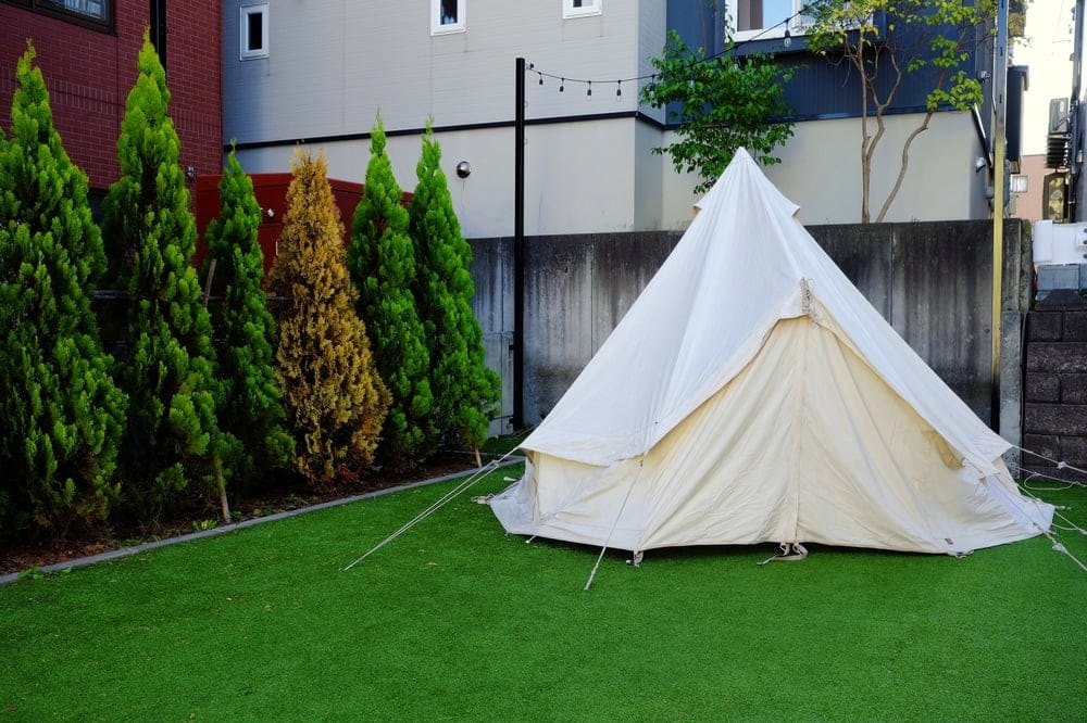 A glamping teepee tent sits on a grassy yard in North Carolina, inviting business opportunities.