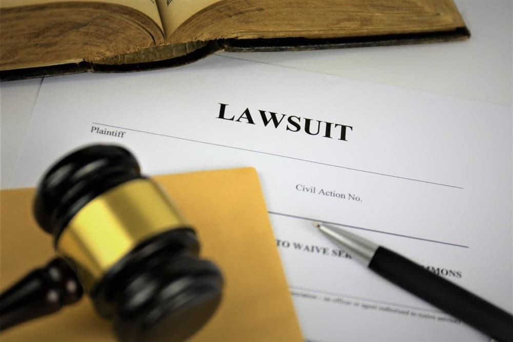 A gavel sits on top of a legal document related to the North Dakota state's operating license for an RV Park.