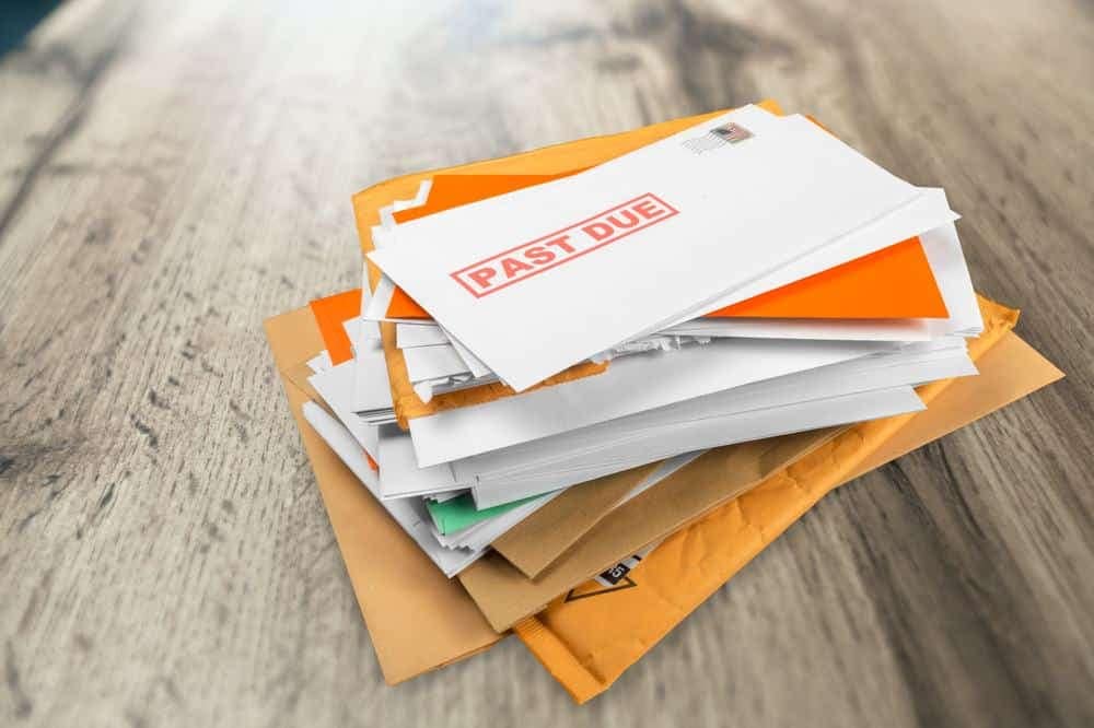 A pile of envelopes labeled 'failure' alongside bills.