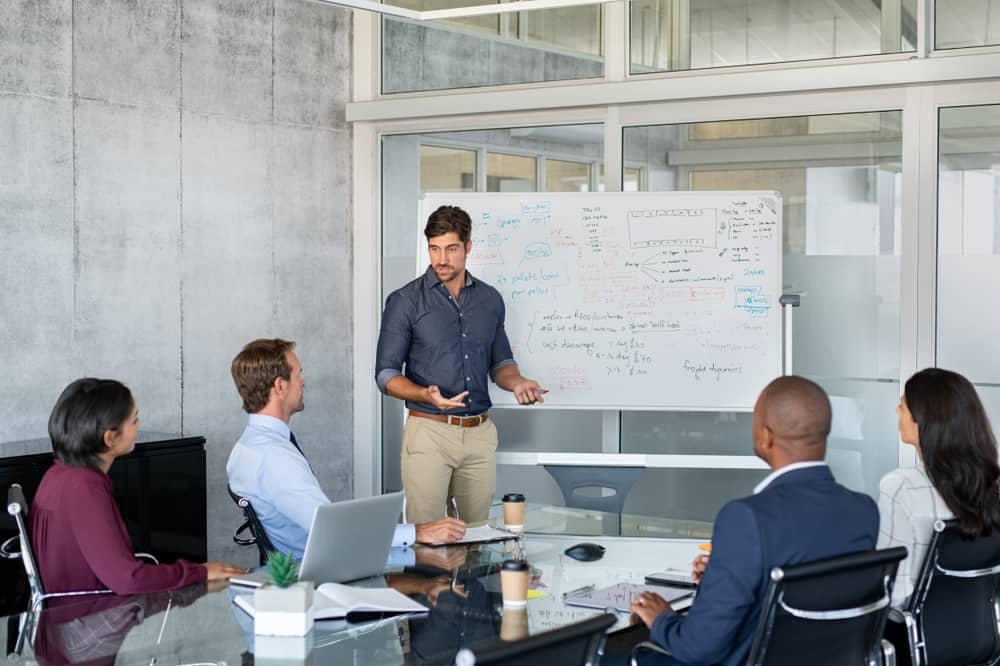 A group of business people in a meeting room discussing the Management Plan for Parks Canada's Mountain National Parks.