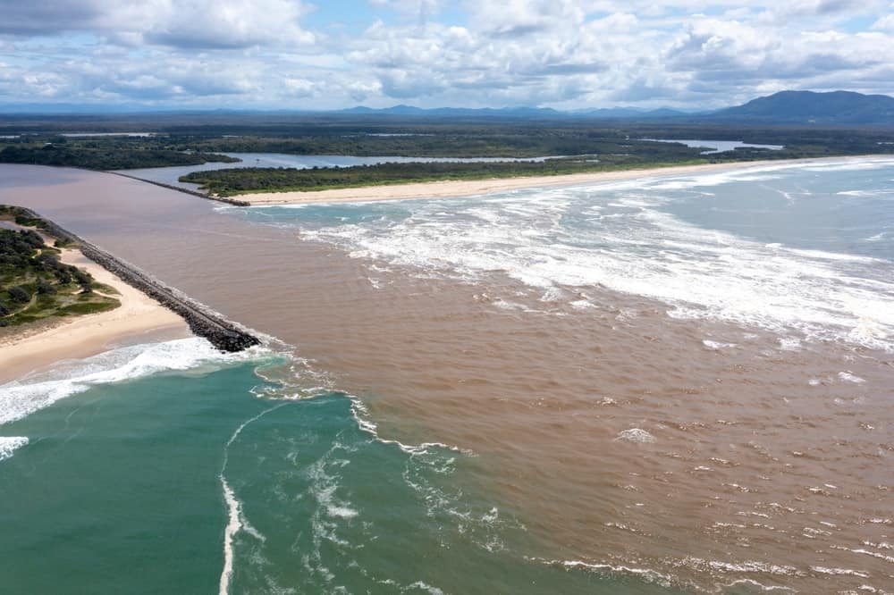 An aerial view of the Macleay Coast with its stunning beaches and endless ocean stretches, inviting nature enthusiasts to explore the untamed beauty of this National Parks destination.