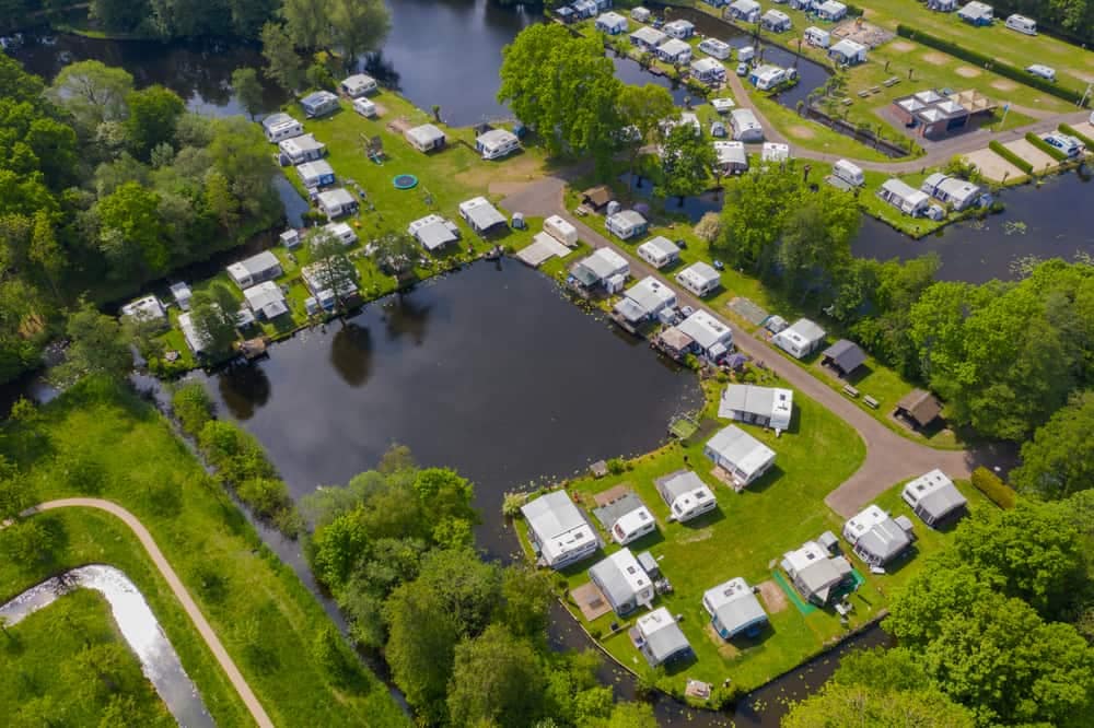 An aerial view of a Europe rv park near a lake, showcasing the Camping Boom.