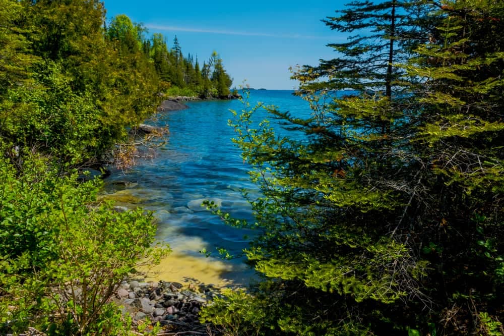 A view of a body of water surrounded by trees in Isle Royale National Park, one of the least-visited National Parks.