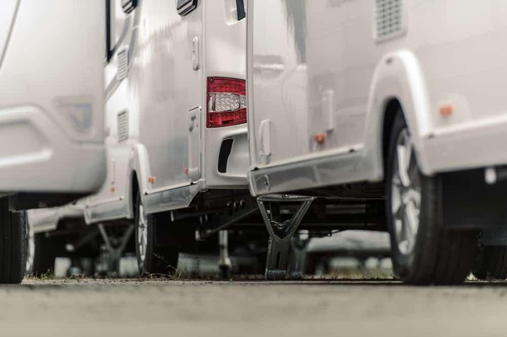 A row of white RVs parked next to each other, as seen in the revised position paper by the RVDA board.