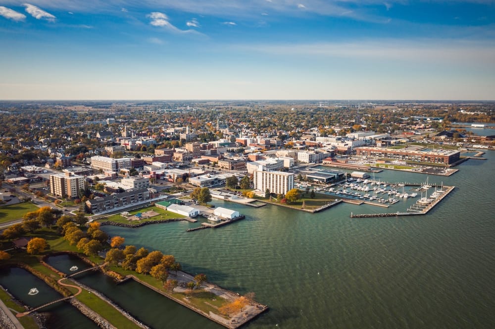 An aerial view of a floating city near the water.