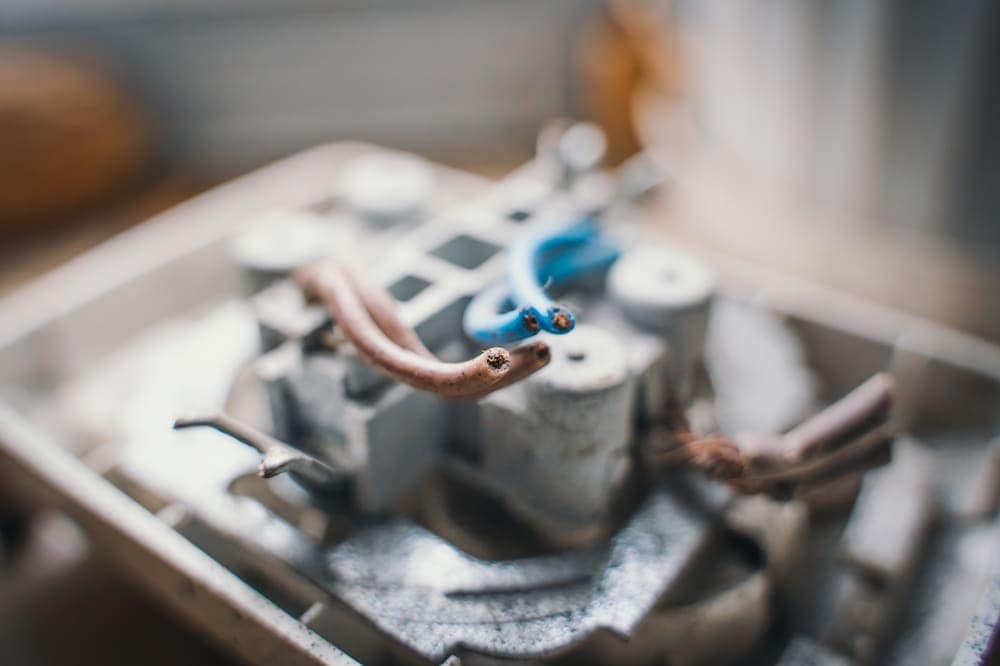 A close up of a metal box with copper wires in it.