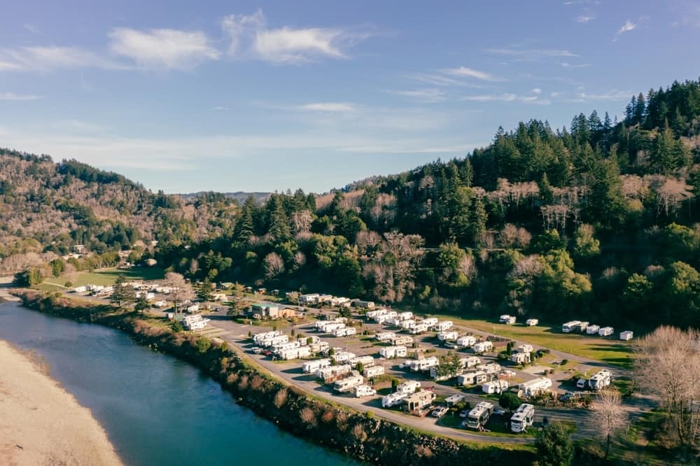 An aerial view of an RV park near a river in Oregon, following the implementation of a new law.