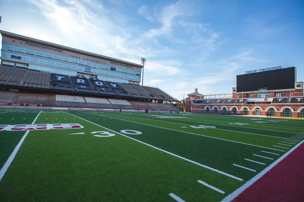 A football field with a stadium in the background, perfect for the Football Season.