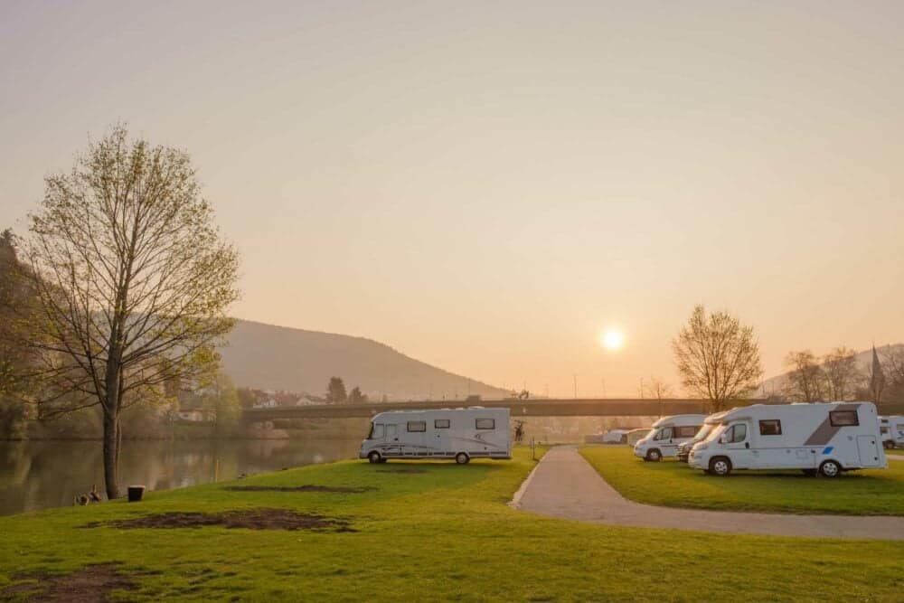 A proposed group of rvs parked on a grassy field near a river, facing a legal hurdle for the 67-Site Washington RV Park.