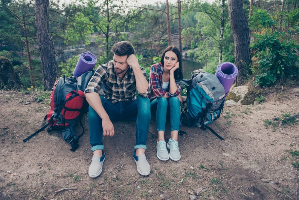 Unhappy Campers sitting in Golden Ears Park with backpacks and yoga mats.