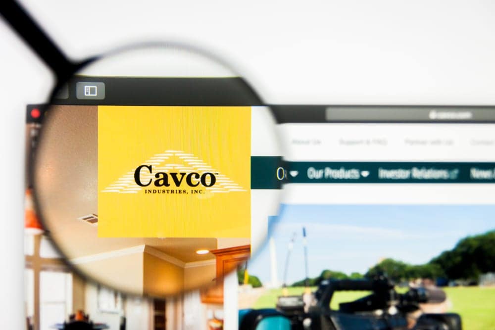 A computer screen displaying the Cavo logo through a magnifying glass.