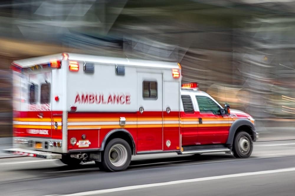 A clear ambulance driving down a city street in Washington City.