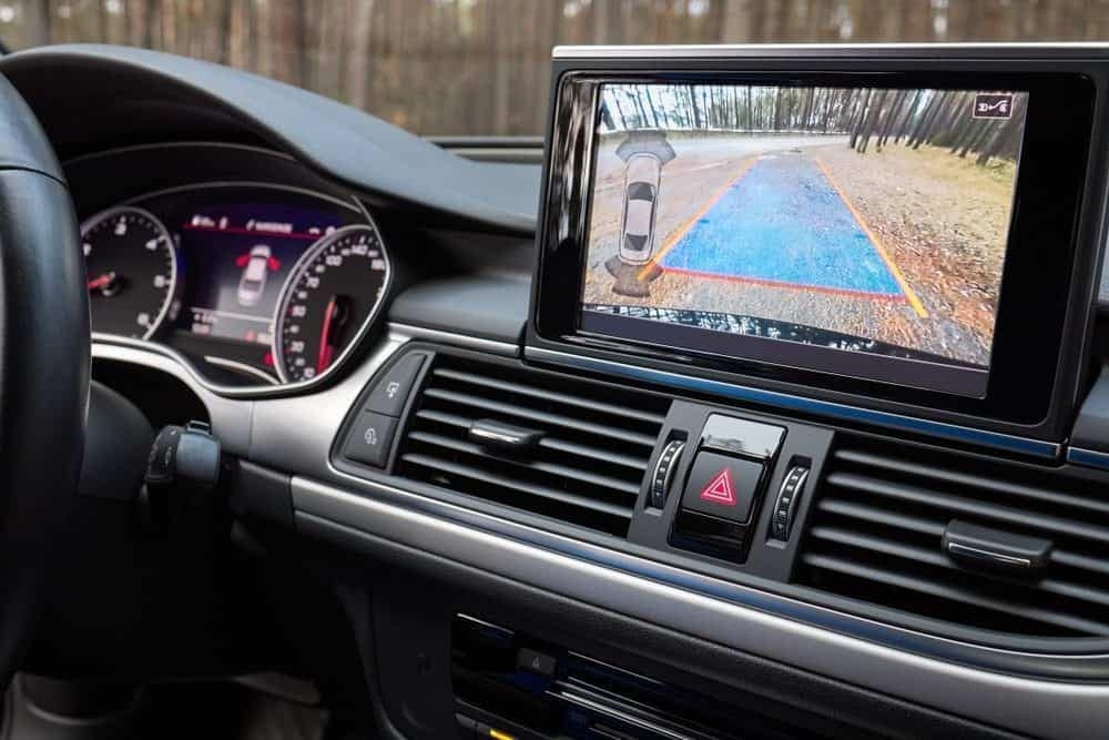 The Continental dashboard of a car with a rear view camera and Turn Assist System for navigating roads.